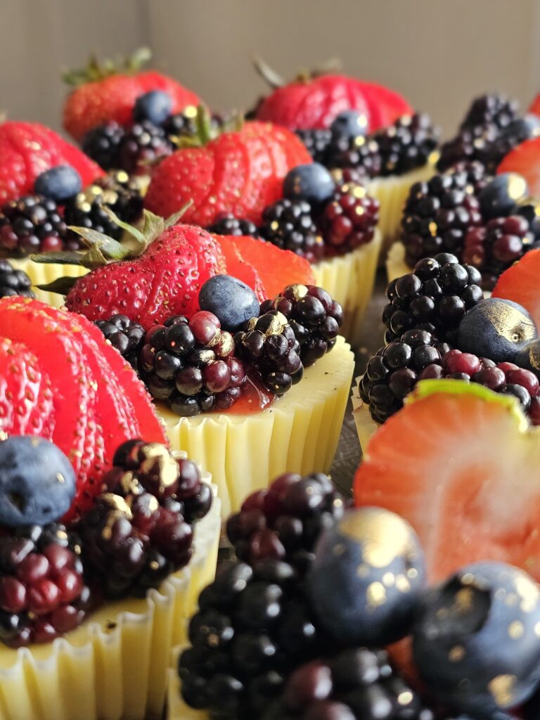 petite cheesecakes topped with seasonal berries